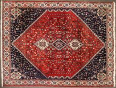 A Badeah style rug, red ground with three central medallions, 267cm x 183cm.