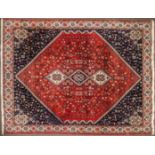 A Badeah style rug, red ground with three central medallions, 267cm x 183cm.