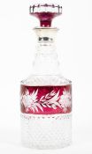 A moulded glass silver collared decanter with etched cranberry glass detail.