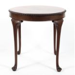 A George III style mahogany round tea table, 20th century, the circular top with gadrooned rim,