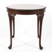 A George III style mahogany round tea table, 20th century, the circular top with gadrooned rim,