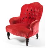 A Victorian button back pink armchair, with shaped back and turned feet, on casters,