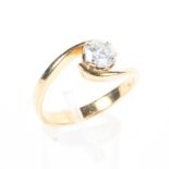 An 18ct gold single stone ring set with a round brilliant cut diamond estimated to weigh