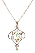 An Art Nouveau yellow metal and peridot set openwork pendant on yellow metal curb link chain.