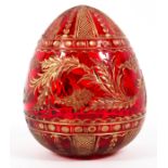 A Faberge (St Petersburg) cut glass gilt ruby egg, 20th century, blue label to underside,