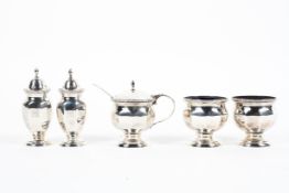 A sterling silver condiment set comprising: two salts and a mustard pot with blue glass liners