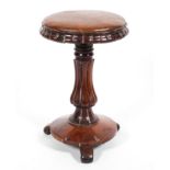A 19th century rosewood adjustable piano stool, on baluster gadrooned stem, on scroll feet,