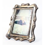 A sterling silver picture frame by Roberts and Briggs. Sheffield,1990. 25cm x 19cm.
