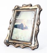 A sterling silver picture frame by Roberts and Briggs. Sheffield,1990. 25cm x 19cm.