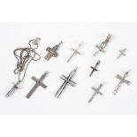 A collection of ten cross pendants, one with chain.