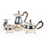 A four piece sterling silver tea set of circular form with flared rim each piece raised on four