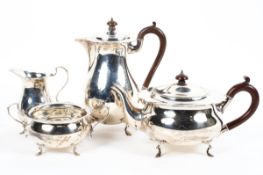 A four piece sterling silver tea set of circular form with flared rim each piece raised on four