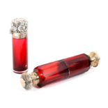A double ended cranberry glass scent bottle and a silver mounted example