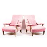 A pair of Victorian walnut framed arm chairs, upholstered in pink damask style fabric,