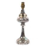 A silver plated baluster lamp base, early 20th century, embossed with scrolls and flowers,