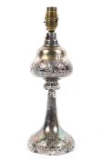 A silver plated baluster lamp base, early 20th century, embossed with scrolls and flowers,