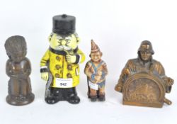 A group of four 20th century money boxes in the shape of figures,