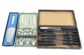 A silver pie knife, a boxed set of teaspoons and a set of bakelite handled knives