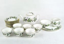 A six person Royal Worcester tea set decorated with branches of flowering and fruiting blackberries