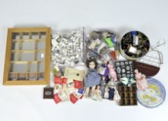 A collection of collectable porcelain thimbles, key rings, display boxes and vintage dolls,