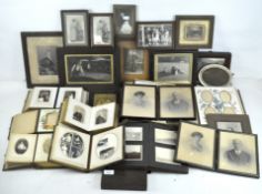 A collection of vintage photographs, mostly portraits, with a wooden box with gilt decoration