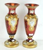 A pair of large cranberry glass vases,