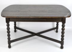 A 20th century oak dining table, with curved corners, on bobbin turned legs and supports,