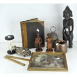 A carved wooden African figure, together with a metal bell and other items