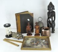 A carved wooden African figure, together with a metal bell and other items