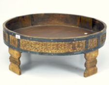 A mid century tub coffee table, of circular form, raised upon four carved feet,