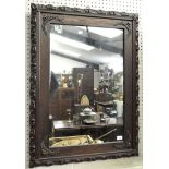 A carved stained oak rectangular mirror, the frame carved with acanthus leaves,