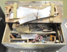 A large vintage wood workbox containing various tools including saws, drills, planes, files,