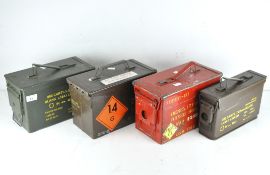 A group of four metal ammunition cases,