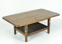 An oak coffee table, with shaped rectangular top above slatted shelf, on tapering square legs,