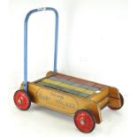 A Triang baby walker, complete with full set of coloured blocks,