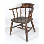 A Victorian oak smokers bow chair, spindle back with tapered turned supports,