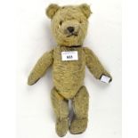 A vintage jointed mohair teddy bear with brown pads, black stitched nose and orange eyes,