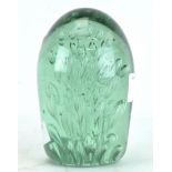 A late 19th/early 20th century light green glass dump paperweight,