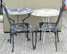 Two circular metal garden tables with pierced and moulded decoration, with tripod supports,