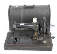 A vintage Singer sewing machine, bearing number 10759209, with gilt decoration and carry case,