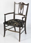 A single Edwardian arm chair, adorned with inlaid foliate and stripe detailing, upholstered seat,