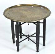 A Middle Eastern brass topped folding table,