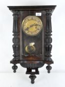 An early 20th century mahogany cased Vienna Wall clock, the dial with Roman numerals denoting hours,