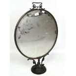 A Victorian fire screen, with central oval mirror within a bronze frame