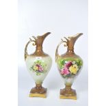 Two large vintage vases in the form of ewer's, decorated with roses on a pale green ground,