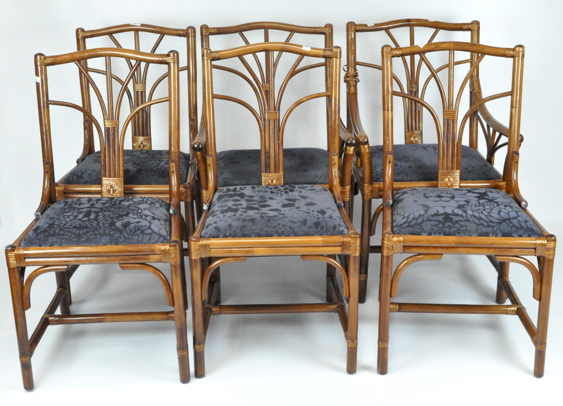 A set of six stained bamboo chairs with lift out upholstered seats,