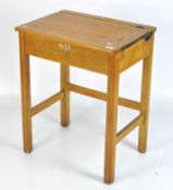 A vintage child's opening desk, with inkwell holder,