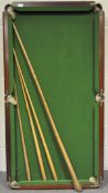 A mahogany framed table top snooker table with three cues,