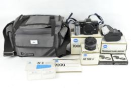 A selection of camera equipment including a Minolta 7000 body, boxed,