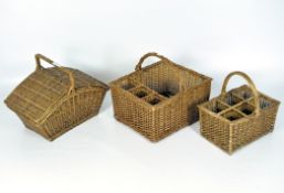Three vintage wicker baskets, including one fitted for six wine bottles,